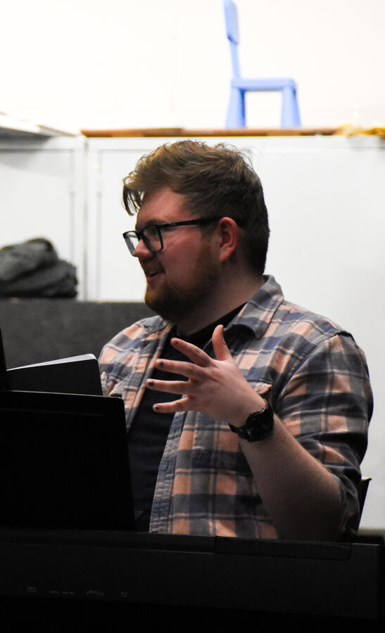 Sam explaining something with jazz hands